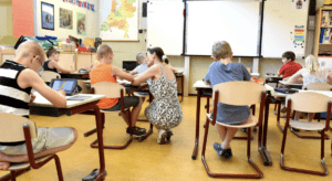 School room with students and teacher.