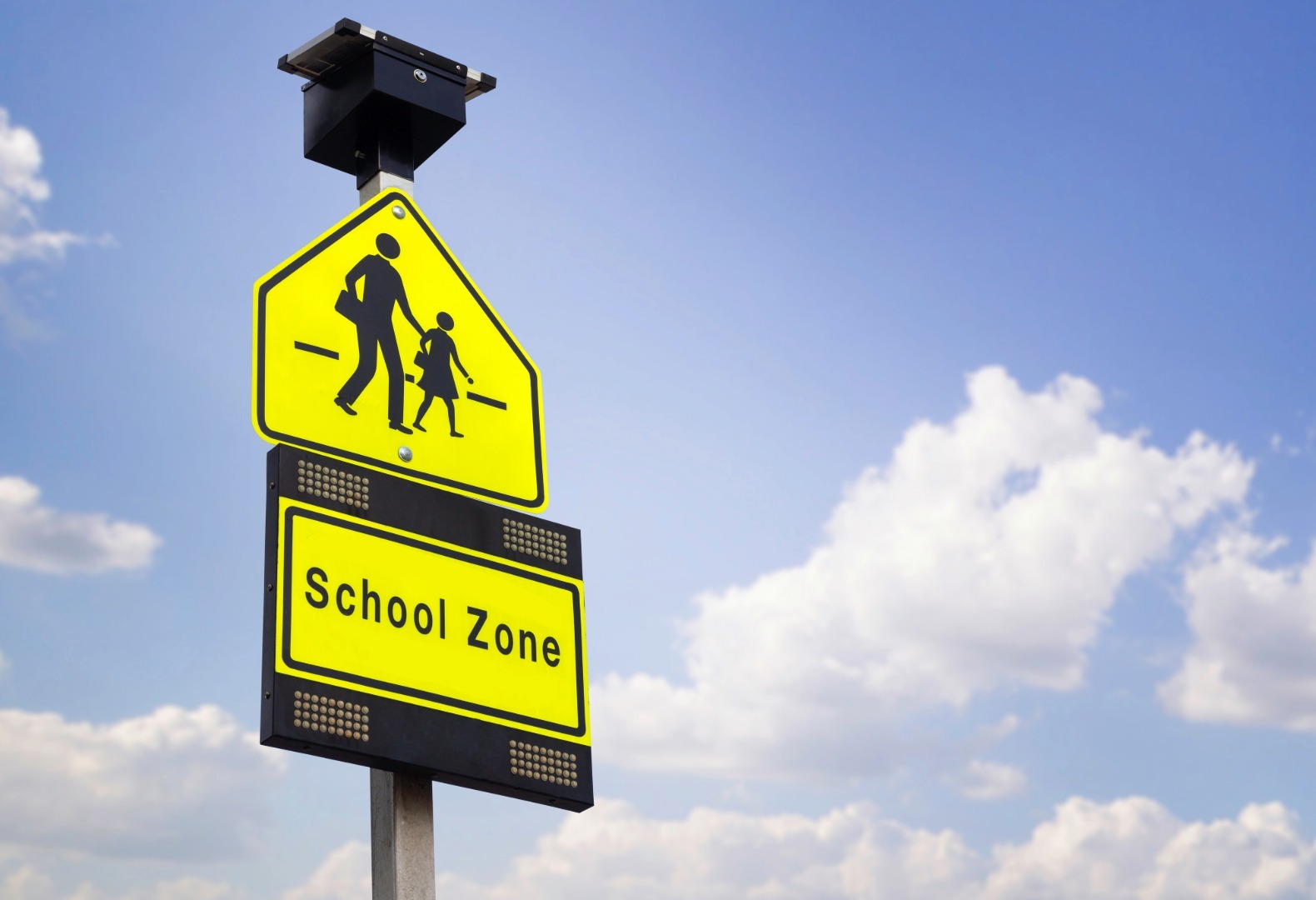 School zone safety sign representing K-12 emergency infrastructure and student protection.