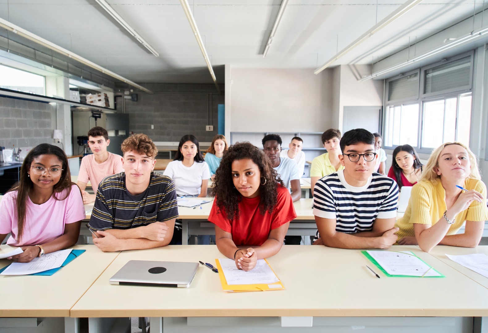 High school students in a classroom with emergency communication infrastructure for K-12 school safety.